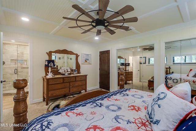 carpeted bedroom with ceiling fan, crown molding, and multiple closets