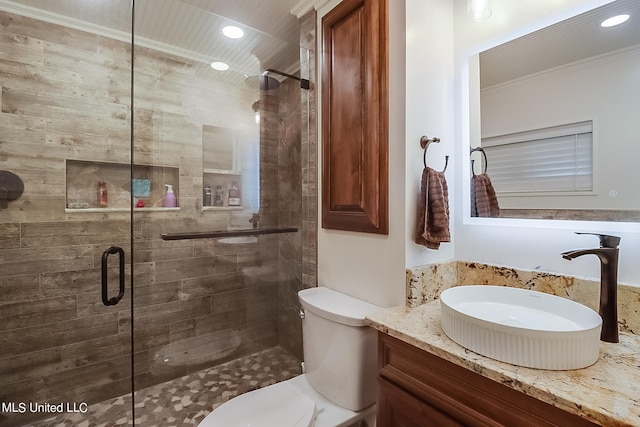 bathroom with toilet, an enclosed shower, ornamental molding, and vanity