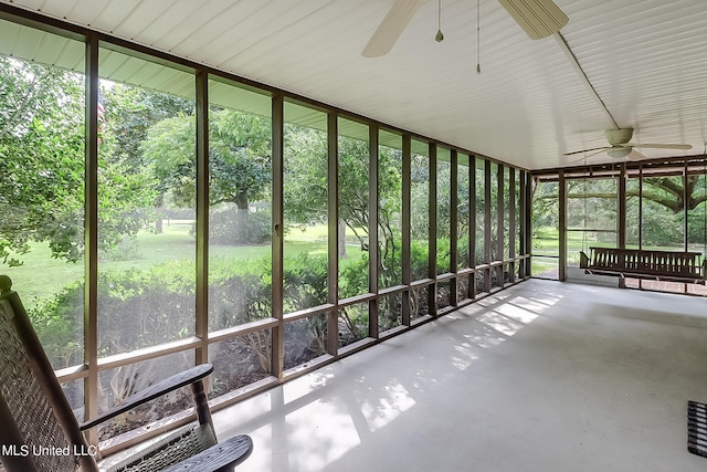 unfurnished sunroom featuring ceiling fan