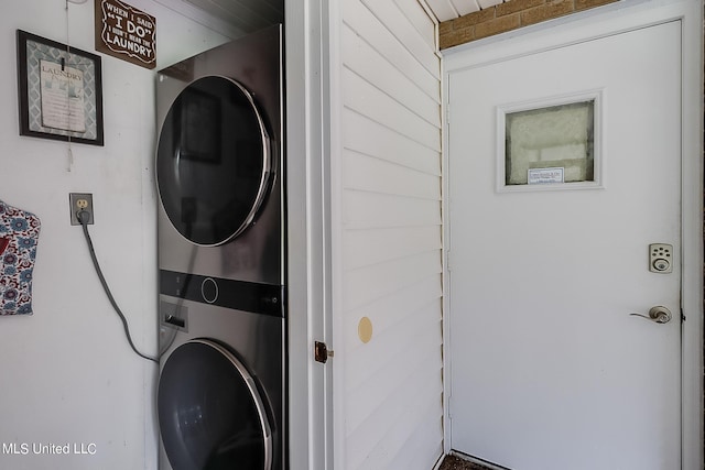 laundry area featuring stacked washing maching and dryer