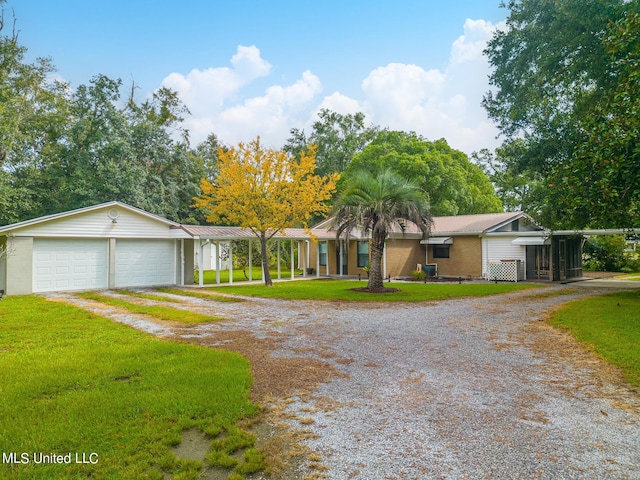 ranch-style house featuring a front yard and a garage