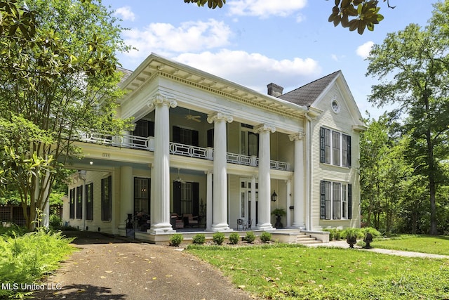 315 N St, Lexington, MS 39095 - greek revival house with a balcony, a chimney, a porch, and a front lawn
