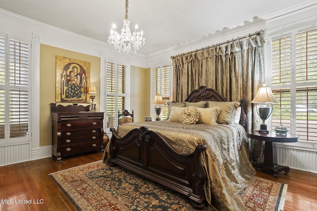 315 N St, Lexington, MS 39095 - bedroom featuring radiator, ornamental molding, an inviting chandelier, and wood finished floors