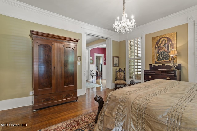 315 N St, Lexington, MS 39095 - bedroom with crown molding, a chandelier, wood finished floors, and baseboards