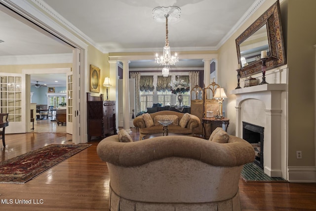 315 N St, Lexington, MS 39095 - living room with dark wood-style flooring, a fireplace, decorative columns, and a wealth of natural light