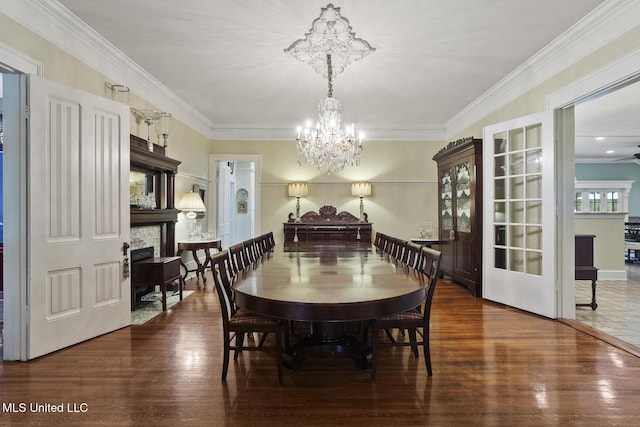 315 N St, Lexington, MS 39095 - dining room featuring wood finished floors, a chandelier, a fireplace, and ornamental molding