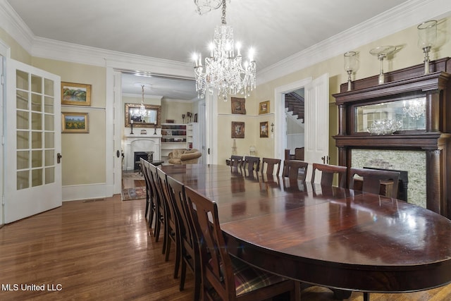 315 N St, Lexington, MS 39095 - dining space with a fireplace, a chandelier, ornamental molding, and wood finished floors