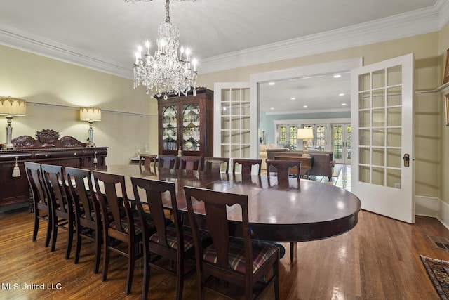 315 N St, Lexington, MS 39095 - dining room featuring visible vents, wood finished floors, ornamental molding, and a notable chandelier