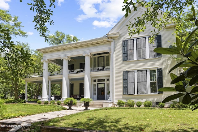 315 N St, Lexington, MS 39095 - view of front of home with a balcony, a porch, and a front lawn