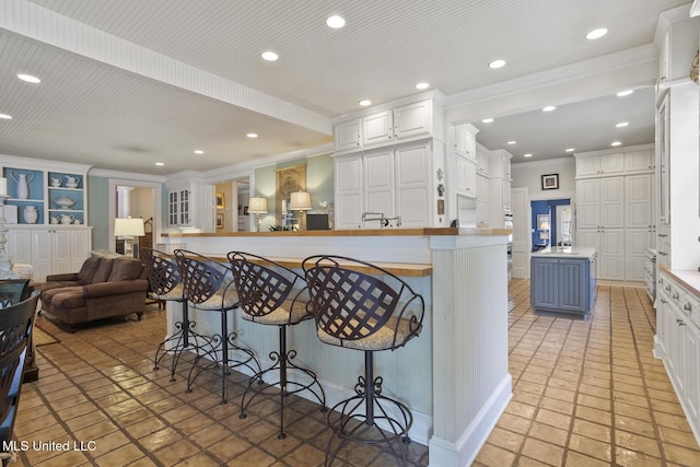 315 N St, Lexington, MS 39095 - kitchen with a kitchen breakfast bar, open floor plan, white cabinetry, a kitchen island, and recessed lighting