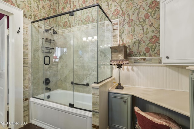 315 N St, Lexington, MS 39095 - bathroom with bath / shower combo with glass door, wallpapered walls, and a wainscoted wall