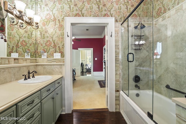 315 N St, Lexington, MS 39095 - full bath featuring crown molding, an inviting chandelier, wallpapered walls, and wood finished floors