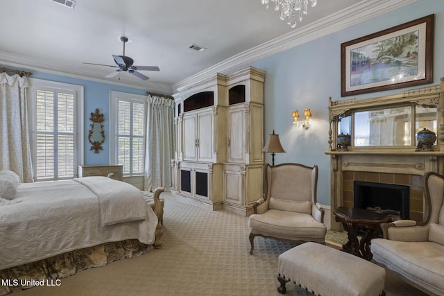 315 N St, Lexington, MS 39095 - bedroom featuring a notable chandelier, a tiled fireplace, visible vents, crown molding, and light carpet