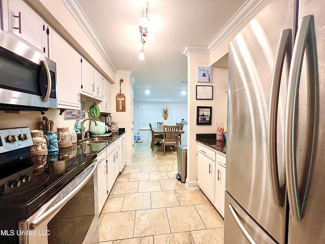 291 Highpoint Dr Unit 291, Diamondhead, MS 39525 - kitchen featuring appliances with stainless steel finishes, crown molding, and white cabinetry
