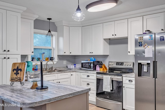 kitchen with decorative light fixtures, sink, white cabinetry, light stone countertops, and stainless steel appliances