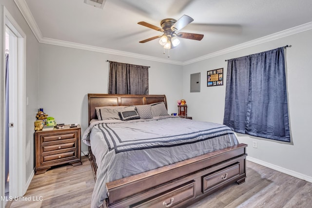 bedroom with ceiling fan, electric panel, ornamental molding, and light wood-type flooring