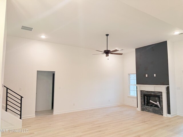 3165 Winterwood Dr, Hernando, MS 38632 - unfurnished living room with a fireplace, light wood-style floors, visible vents, and ceiling fan