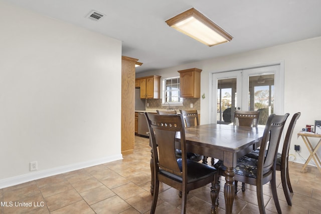 dining area with french doors and light tile patterned flooring