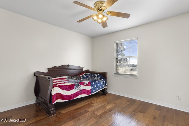 bedroom with dark hardwood / wood-style flooring and ceiling fan