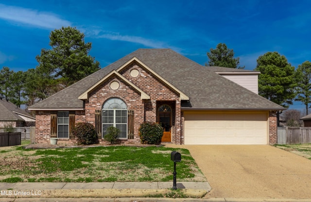 view of front of house with a garage and a front lawn