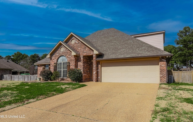 view of front of home featuring a garage, a front lawn, and central air condition unit