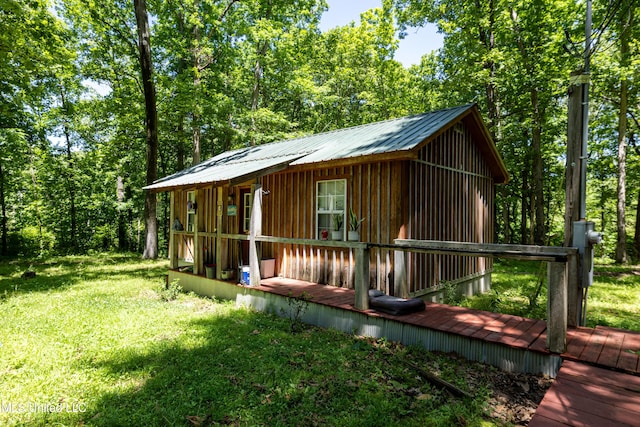 6869 Compress Rd # F, Como, MS 38619 - view of front of home with a front lawn, a metal roof, an outdoor structure, and a deck