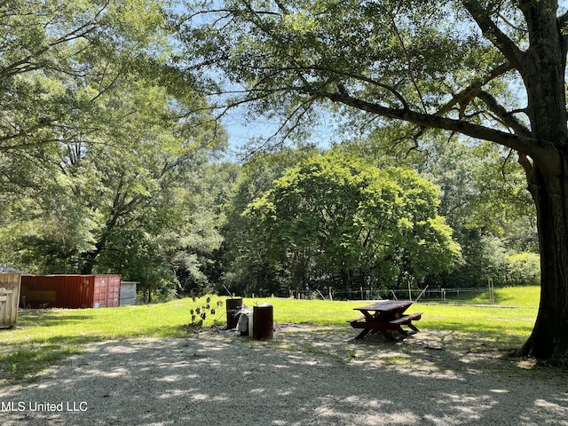 6869 Compress Rd # F, Como, MS 38619 - view of home's community with an outbuilding, a lawn, and a pole building