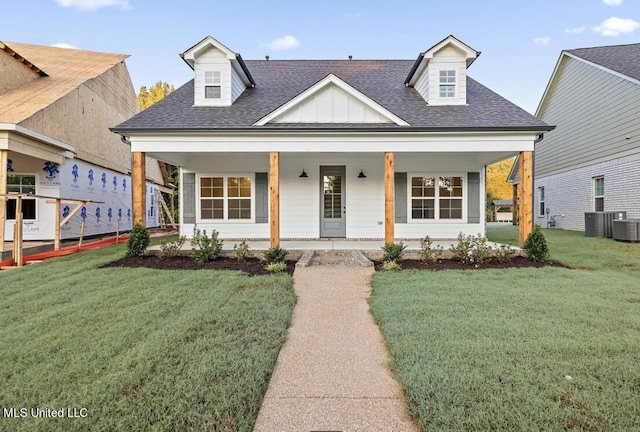 view of front of house featuring a front yard and cooling unit