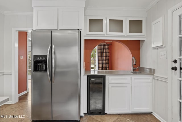 kitchen featuring stainless steel fridge with ice dispenser, wine cooler, glass insert cabinets, crown molding, and white cabinetry