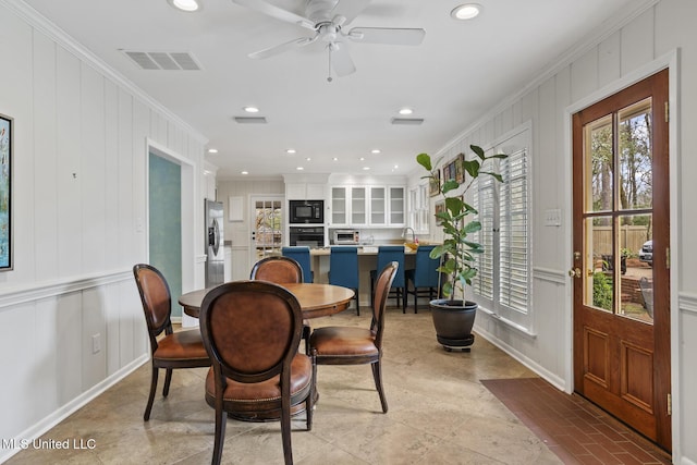 dining area with recessed lighting, visible vents, crown molding, and a decorative wall