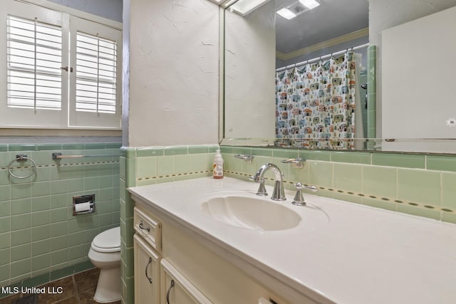 full bathroom with toilet, vanity, tile walls, wainscoting, and crown molding