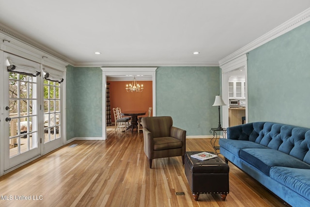 living room featuring baseboards, wood finished floors, crown molding, a notable chandelier, and recessed lighting