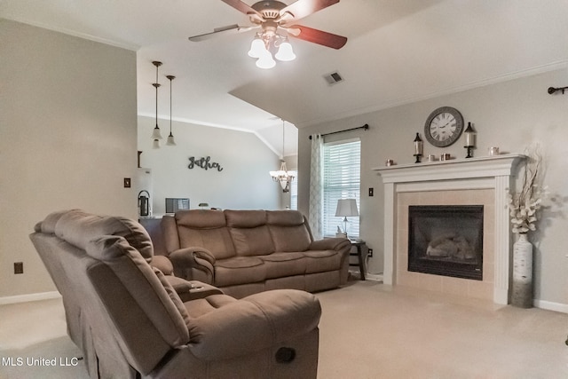 living room with crown molding, a fireplace, lofted ceiling, light colored carpet, and ceiling fan with notable chandelier