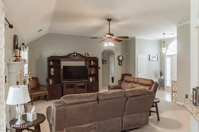 living room with lofted ceiling, ceiling fan, crown molding, and light carpet