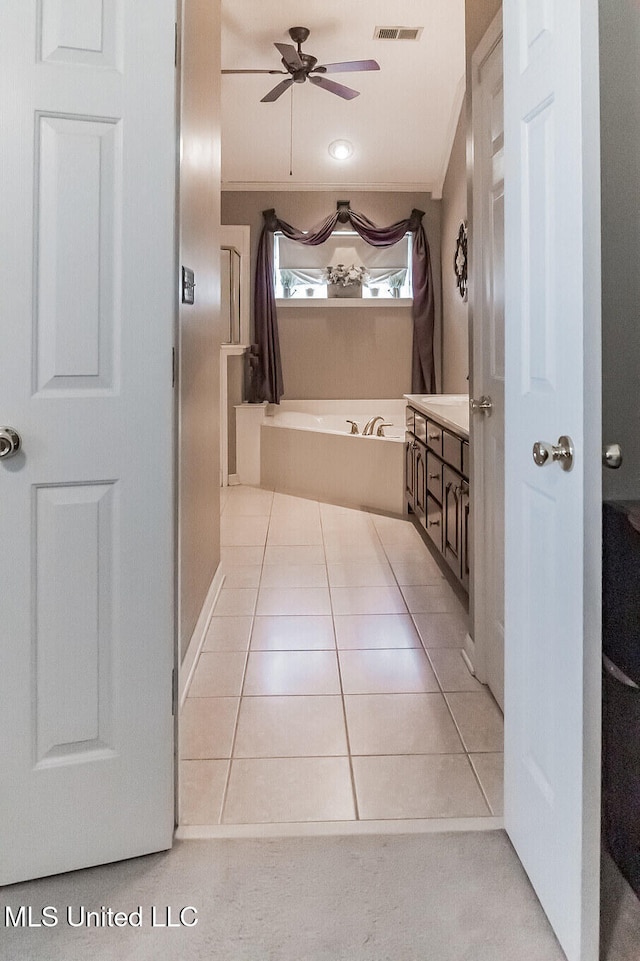 bathroom with tile patterned flooring, ceiling fan, and crown molding