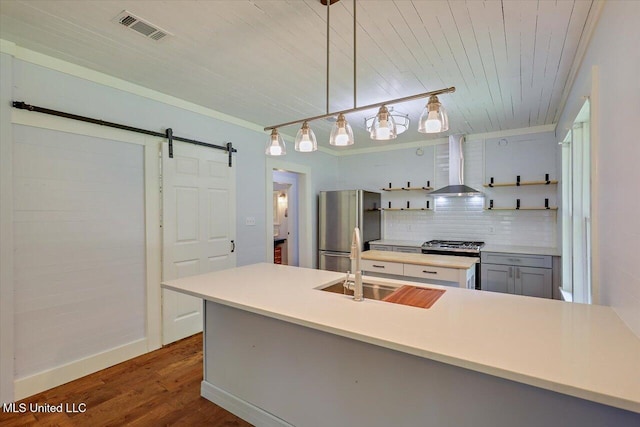 873 SCR 142, Morton, MS 39117 - kitchen featuring wall chimney range hood, appliances with stainless steel finishes, open shelves, a barn door, and wood ceiling