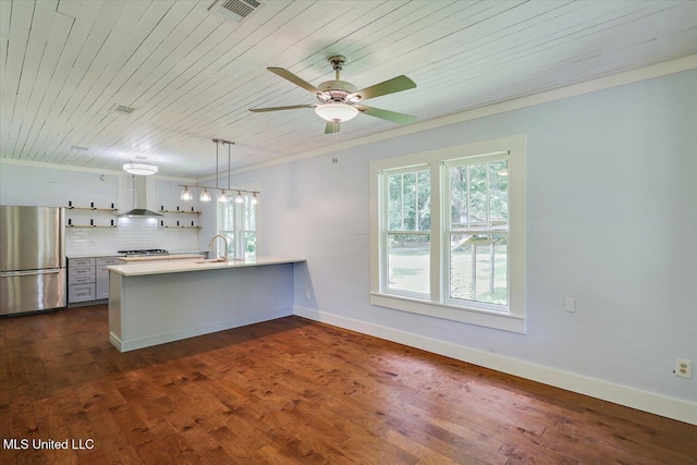 873 SCR 142, Morton, MS 39117 - kitchen featuring stainless steel appliances, wood ceiling, healthy amount of natural light, a peninsula, and decorative backsplash