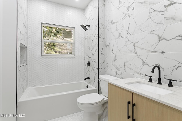 full bathroom with tile patterned flooring, toilet, vanity, tile walls, and tiled shower / bath