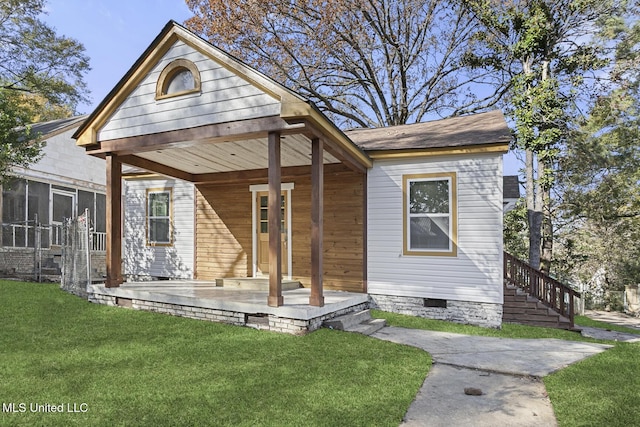 bungalow-style house with a front lawn and a sunroom