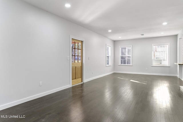 spare room featuring dark wood-type flooring