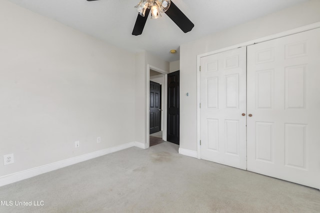 unfurnished bedroom featuring a closet, carpet flooring, a ceiling fan, and baseboards