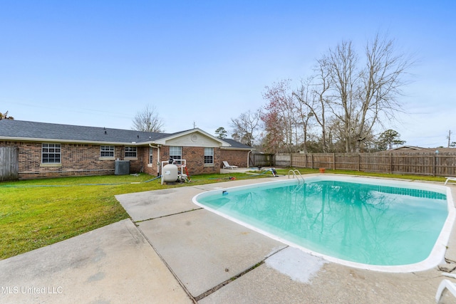 view of swimming pool with a fenced in pool, central AC, a yard, and a fenced backyard