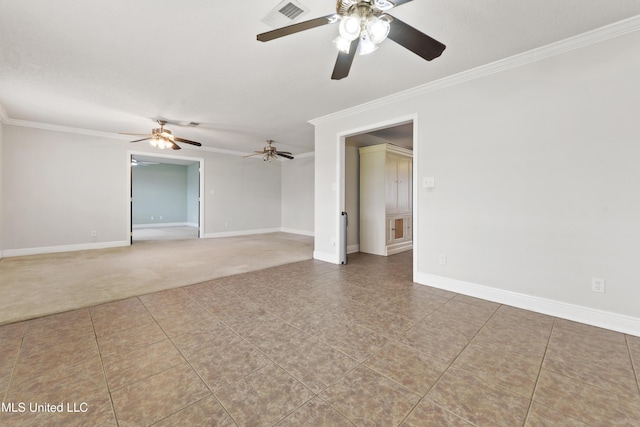 unfurnished room with baseboards, visible vents, ornamental molding, and carpet flooring