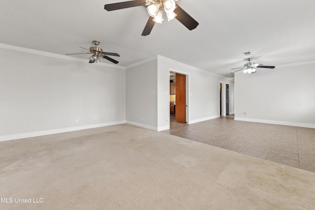 carpeted empty room with ornamental molding, tile patterned flooring, and baseboards