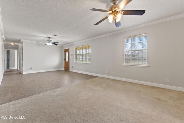 tiled spare room featuring a textured ceiling, carpet floors, visible vents, and crown molding