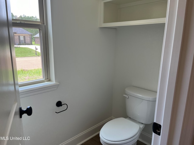 bathroom with toilet and a healthy amount of sunlight