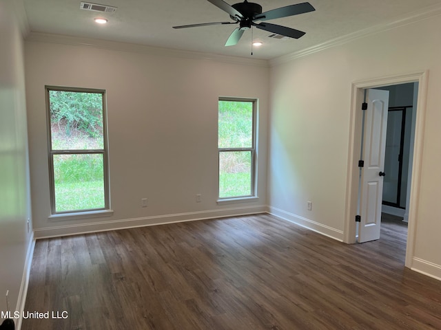 spare room with crown molding, dark hardwood / wood-style floors, and ceiling fan