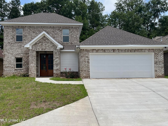 view of front facade featuring a front yard and a garage