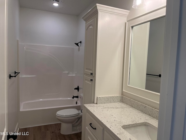 full bathroom with toilet, shower / washtub combination, vanity, and wood-type flooring