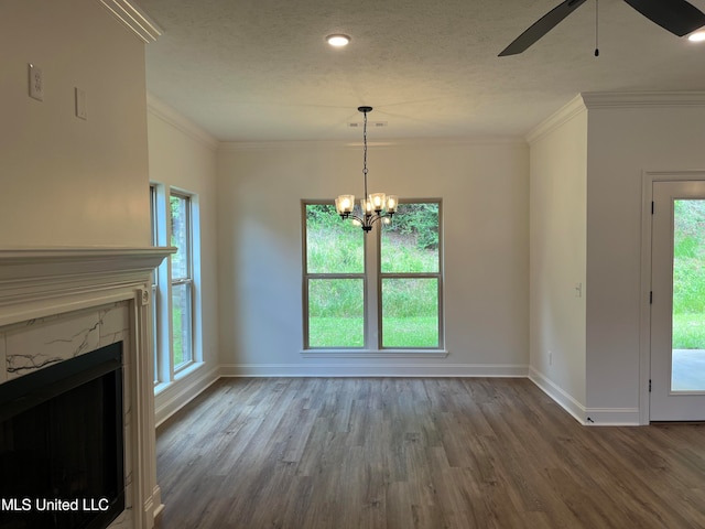 unfurnished dining area with a wealth of natural light, ornamental molding, and wood-type flooring